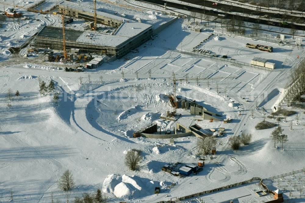 Berlin from above - Wintry snowy construction work for a new stage on site of the IGA 2017 in the district of Marzahn-Hellersdorf in Berlin. The heart of the International gerden exibition will be the Gaerten der Welt. The open air stage is being built near the main entrance on Blumberger Damm