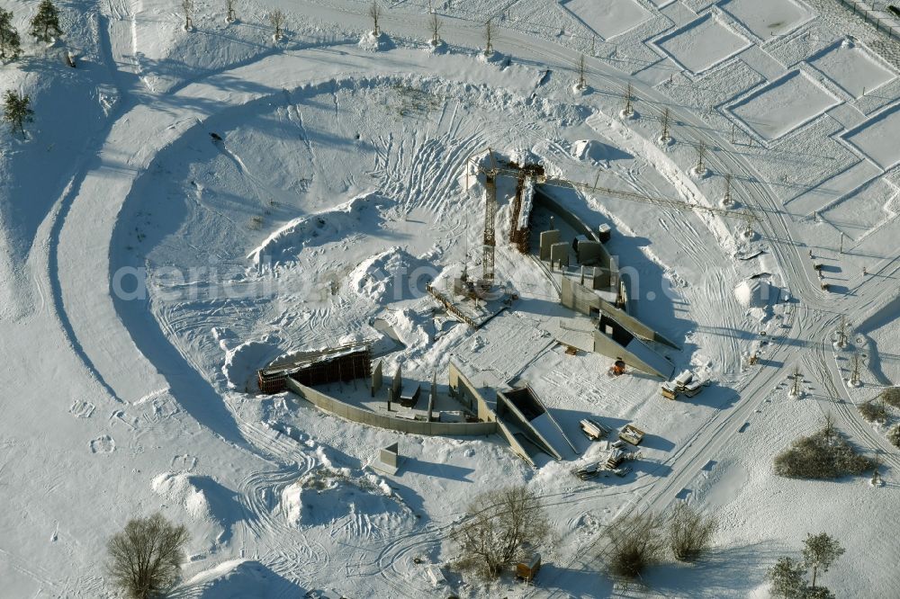 Berlin from above - Wintry snowy construction work for a new stage on site of the IGA 2017 in the district of Marzahn-Hellersdorf in Berlin. The heart of the International gerden exibition will be the Gaerten der Welt. The open air stage is being built near the main entrance on Blumberger Damm