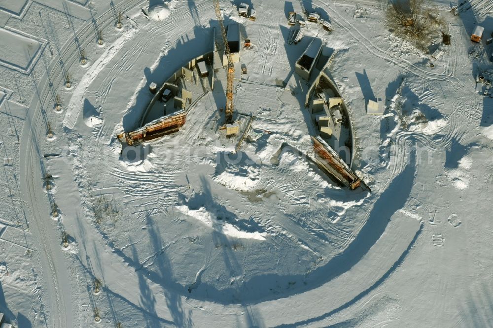 Berlin from the bird's eye view: Wintry snowy construction work for a new stage on site of the IGA 2017 in the district of Marzahn-Hellersdorf in Berlin. The heart of the International gerden exibition will be the Gaerten der Welt. The open air stage is being built near the main entrance on Blumberger Damm