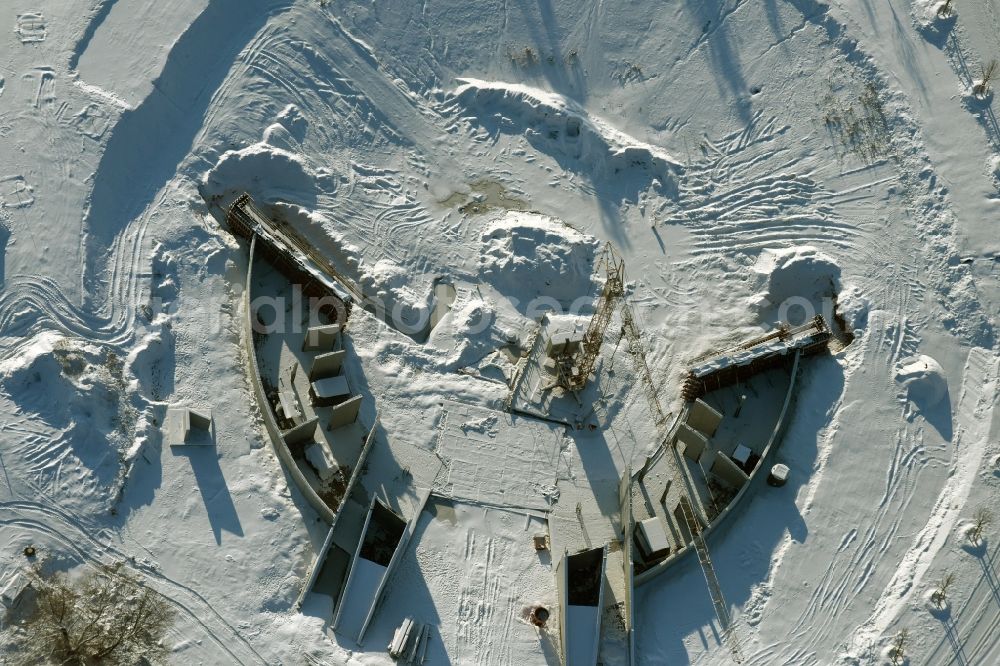 Aerial photograph Berlin - Wintry snowy construction work for a new stage on site of the IGA 2017 in the district of Marzahn-Hellersdorf in Berlin. The heart of the International gerden exibition will be the Gaerten der Welt. The open air stage is being built near the main entrance on Blumberger Damm