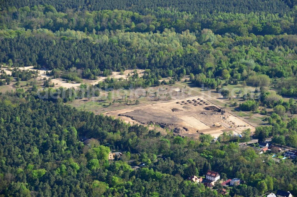 Stahnsdorf from the bird's eye view: Construction works on the Kanalaue Region in Stahnsdorf in the state Brandenburg. The landscape is being developed as a tourism and green region. Several machines and vehicles are working on the open sandy area which is surrounded by forest