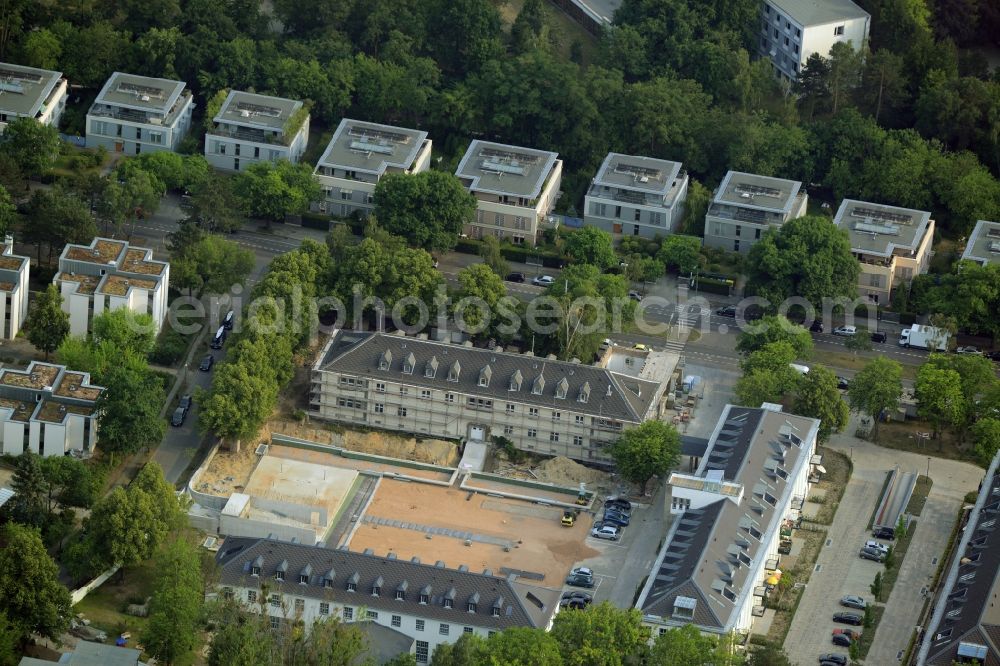 Berlin from the bird's eye view: Construction works for a residential area on site of the former US-Army-Headquarters in the Zehlendorf part of Berlin in Germany. The former army and military base is being redeveloped and new apartments, flats and accommodations are being created. The military buildings are refurbished