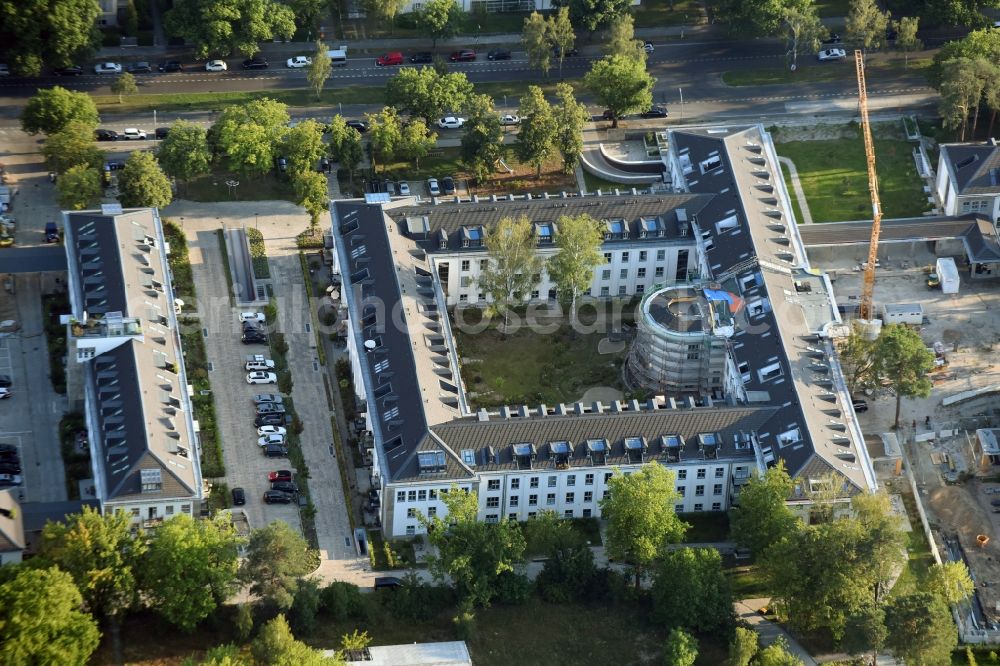 Aerial photograph Berlin - Construction works for a residential area on site of the former US-Army-Headquarters in the Zehlendorf part of Berlin in Germany. The former army and military base is being redeveloped and new apartments, flats and accommodations are being created. The military buildings are refurbished