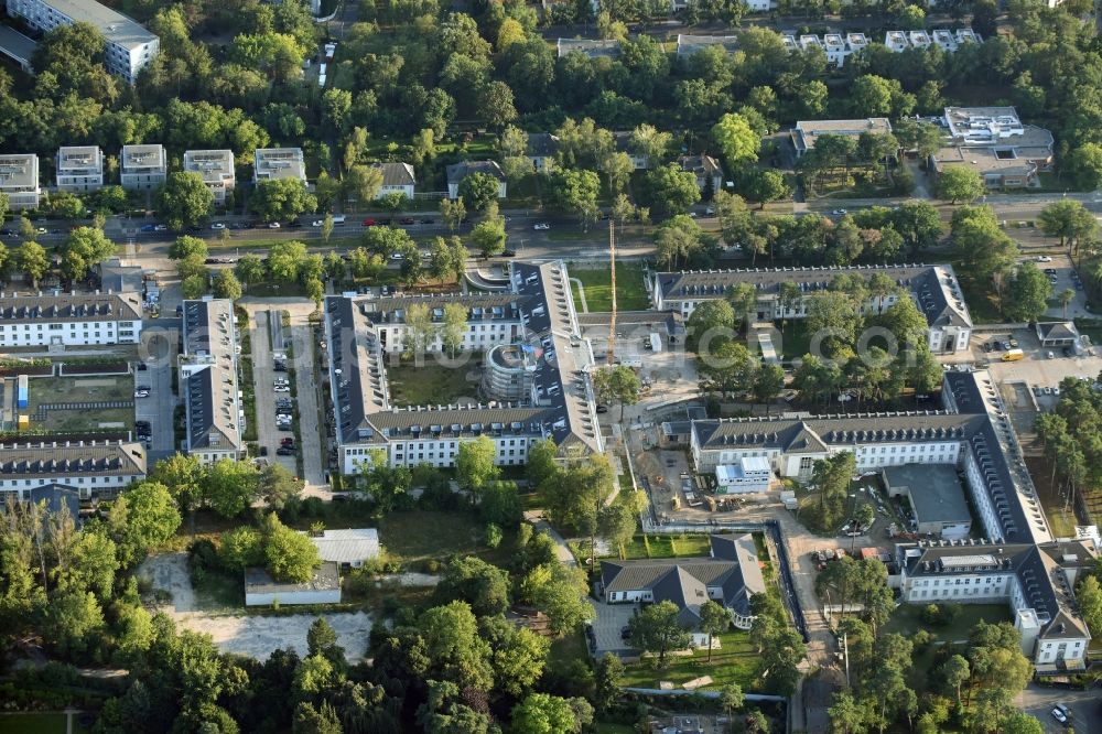 Berlin from the bird's eye view: Construction works for a residential area on site of the former US-Army-Headquarters in the Zehlendorf part of Berlin in Germany. The former army and military base is being redeveloped and new apartments, flats and accommodations are being created. The military buildings are refurbished