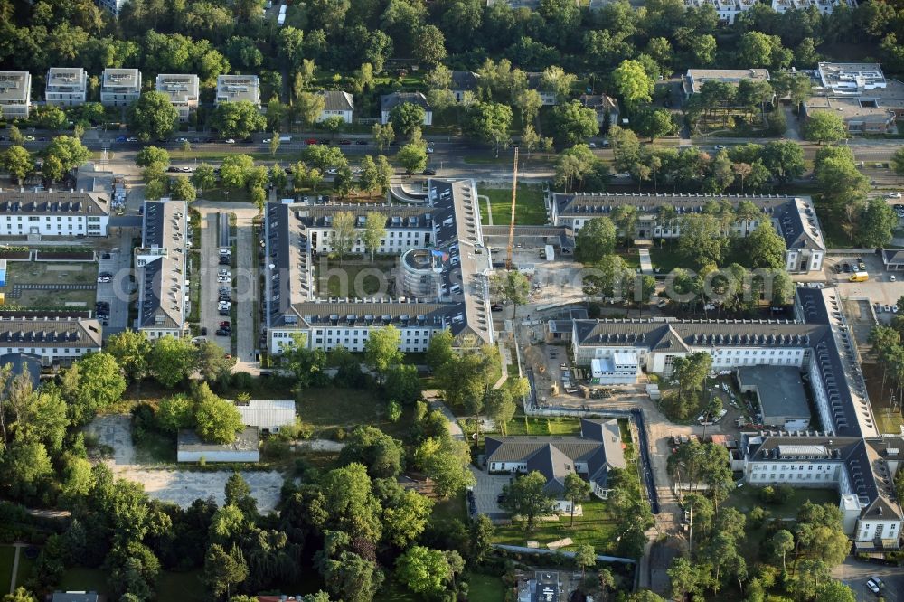 Aerial image Berlin - Construction works for a residential area on site of the former US-Army-Headquarters in the Zehlendorf part of Berlin in Germany. The former army and military base is being redeveloped and new apartments, flats and accommodations are being created. The military buildings are refurbished