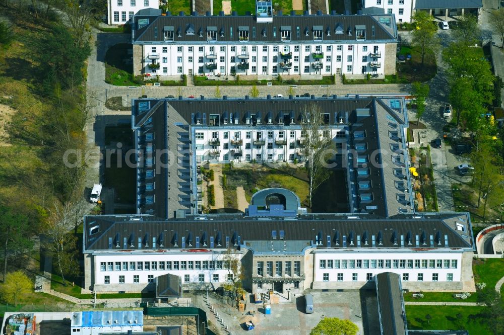 Aerial photograph Berlin - Construction works for a residential area on site of the former US-Army-Headquarters in the Zehlendorf part of Berlin in Germany. The former army and military base is being redeveloped and new apartments, flats and accommodations are being created. The military buildings are refurbished