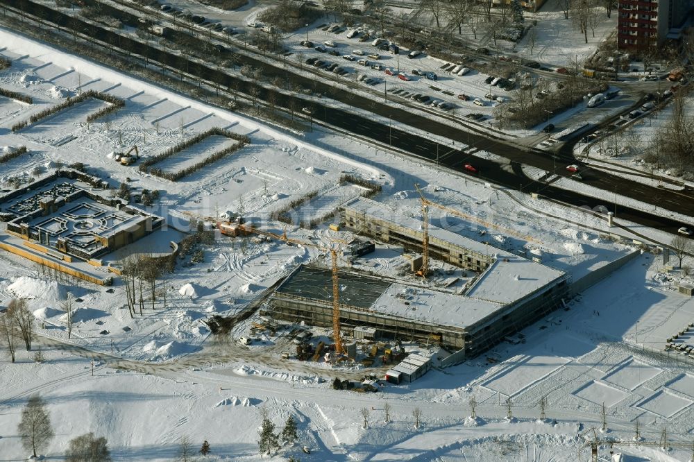 Berlin from above - Wintry snowy construction work for the visitor's centre at the main entrance of the IGA 2017 in the district of Marzahn-Hellersdorf in Berlin. The heart of the International gerden exibition will be the Gaerten der Welt. The visitor's centre is being built near the main entrance on Blumberger Damm