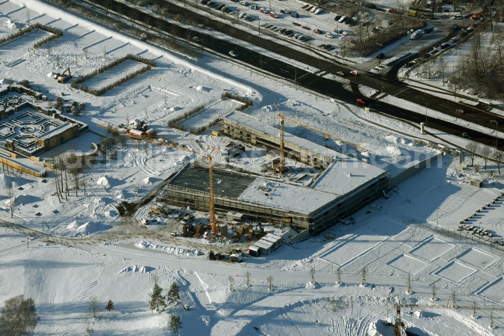 Berlin from the bird's eye view: Wintry snowy construction work for the visitor's centre at the main entrance of the IGA 2017 in the district of Marzahn-Hellersdorf in Berlin. The heart of the International gerden exibition will be the Gaerten der Welt. The visitor's centre is being built near the main entrance on Blumberger Damm