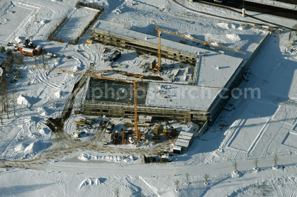 Aerial image Berlin - Wintry snowy construction work for the visitor's centre at the main entrance of the IGA 2017 in the district of Marzahn-Hellersdorf in Berlin. The heart of the International gerden exibition will be the Gaerten der Welt. The visitor's centre is being built near the main entrance on Blumberger Damm