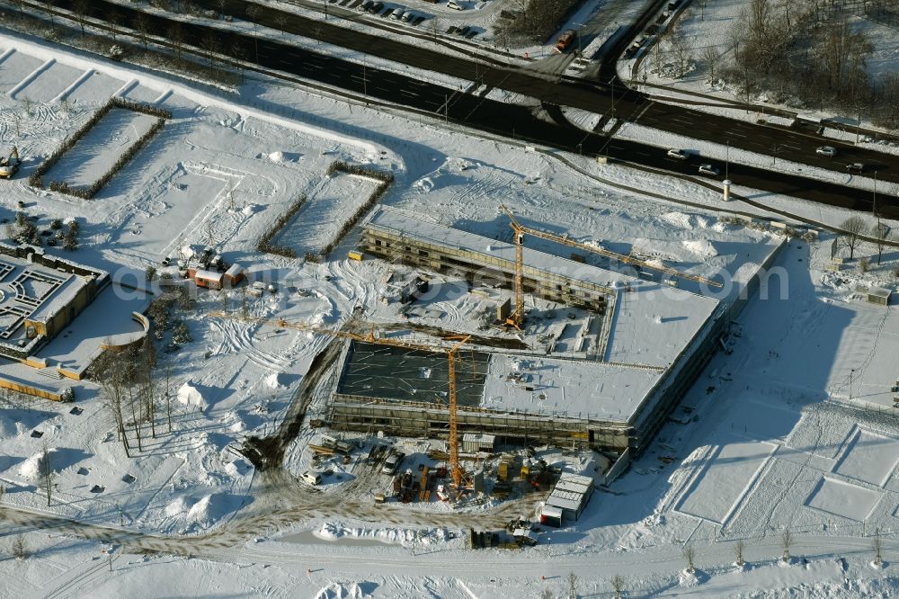 Aerial photograph Berlin - Wintry snowy construction work for the visitor's centre at the main entrance of the IGA 2017 in the district of Marzahn-Hellersdorf in Berlin. The heart of the International gerden exibition will be the Gaerten der Welt. The visitor's centre is being built near the main entrance on Blumberger Damm