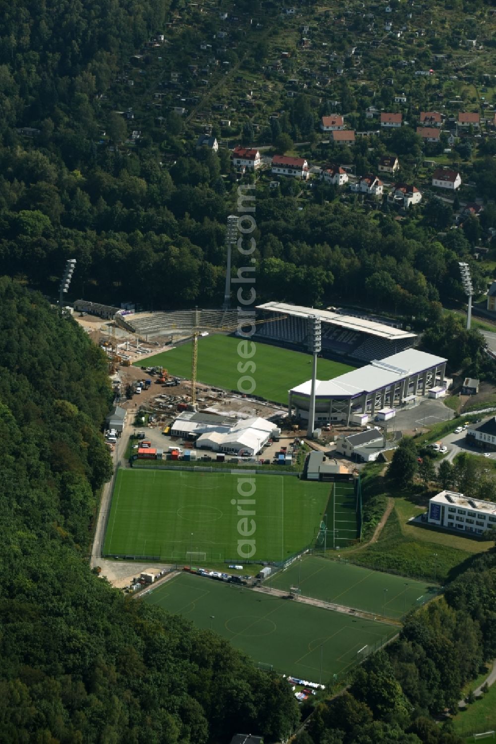 Aue from the bird's eye view: Construction site to redevelop the football stadium Sparkassen-Erzgebirgsstadion of FC Erzgebirge Aue in Aue in the state of Saxony. Parts of the stadium are being demolished, refurbished and new stands are being built