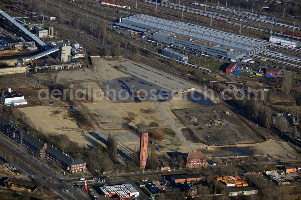 Aerial photograph Berlin - The broke surface at the Klingenberg power plant in Berlin-Rummelsburg extends at an angle of Koepenick Chaussee and the Blockdammweg. The listed water tower stands in the foreground. In the background the halls of the ICE facility Rummelsburg can be seen