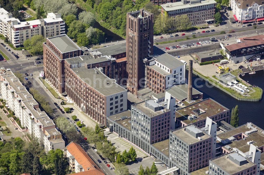 Berlin from above - Historical monument and building Ullsteinhaus on the harbour of Tempelhof in Berlin, Germany. The building is known for its tower and used as a medical center, business building and arts and culture center