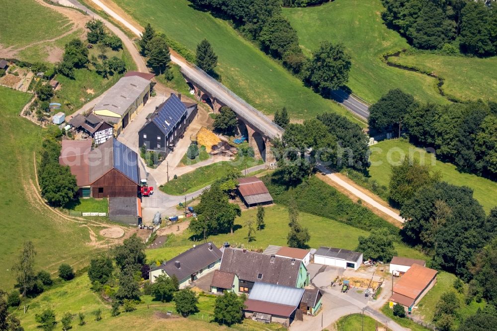 Bredenscheid from the bird's eye view: Agricultural farms and estates on a street viaduct in Bredenscheid in the state of North Rhine-Westphalia