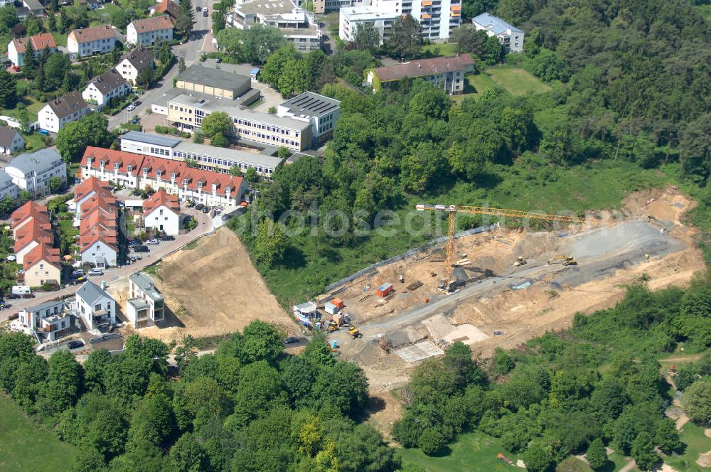 Aerial photograph Bad Vilbel - Blick die Baustelle der Wohnanlage am Tannenweg der cds Wohnbau GmbH. In Waldrandlage entstehen hier mehrere Wohnneubauten durch die cds Wohnbau GmbH, einem Frankfurter Immobiliendienstleister. View the construction site of new development on Tannenweg. At the forest are several new residential buildings caused by the CDS Wohnbau GmbH, a Frankfurt real estate service providers.