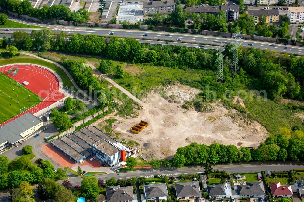 Hagen from the bird's eye view: Construction and development area at the football stadium Kirchberg in the Henkhausen part of Hohenlimburg in Hagen in the state of North Rhine-Westphalia