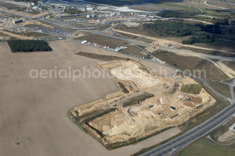 Aerial photograph Schönefeld - Blick auf Baulogistik- Bereiche am Neubaufeld zum Flughafen Berlin-Schönefeld BBI (SXF) Ausführende Firmen: Hochtief AG; EUROVIA Beton; PORR; BERGER Bau; Kark Weiss; Matthai; Schäler Bau Berlin GmbH; STRABAG; MAX BÖGL