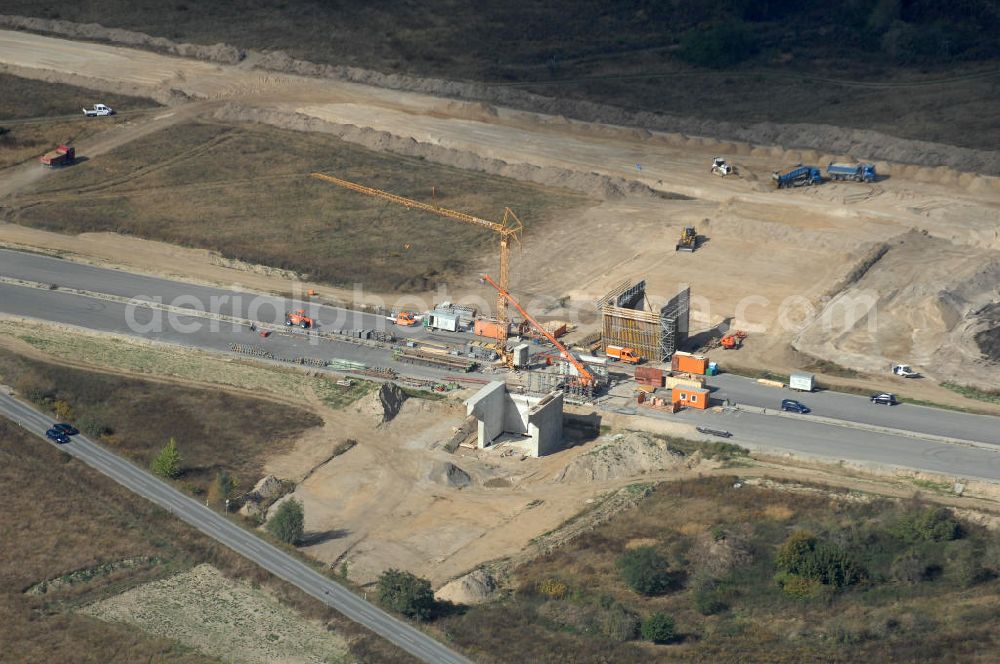 Aerial photograph Schönefeld - Blick auf Baulogistik- Bereiche am Neubaufeld zum Flughafen Berlin-Schönefeld BBI (SXF) Ausführende Firmen: Hochtief AG; EUROVIA Beton; PORR; BERGER Bau; Kark Weiss; Matthai; Schäler Bau Berlin GmbH; STRABAG; MAX BÖGL