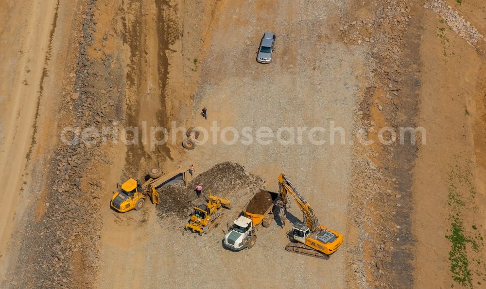 Meschede from the bird's eye view: Construction machines at the construction site for the new building of routing and traffic lanes over the highway bridge in the motorway A46 in Meschede in the state North Rhine-Westphalia