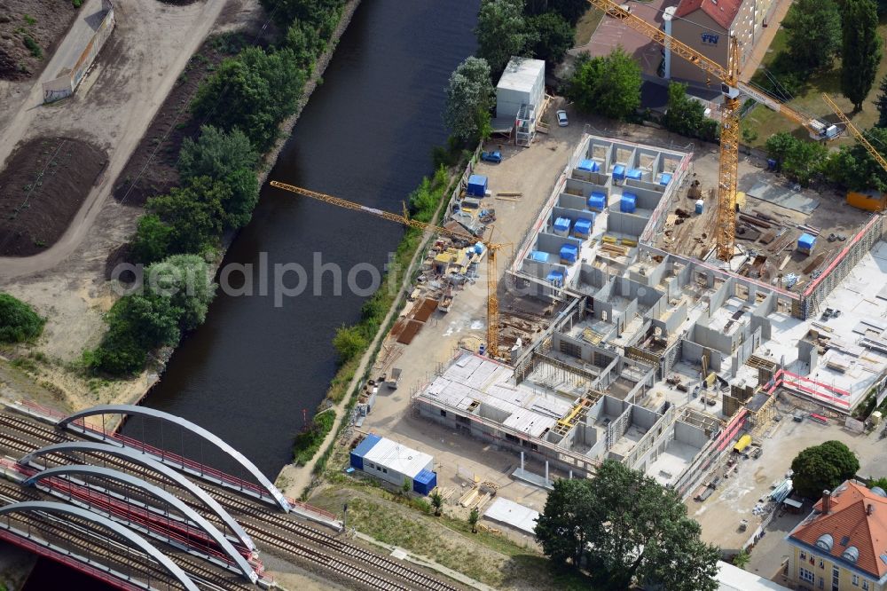 Berlin from above - Construction site of a care home for the elderly in the Baumschulenweg part of the district of Treptow-Köpernick in Berlin in the state of Brandenburg. The future care facility will provide living space for 200 inhabitants. The site is located at the Britzer Verbindungskanal (channel) and the newly built railway bridge. The name Baumschulenweg stems from the former nursery garden located here