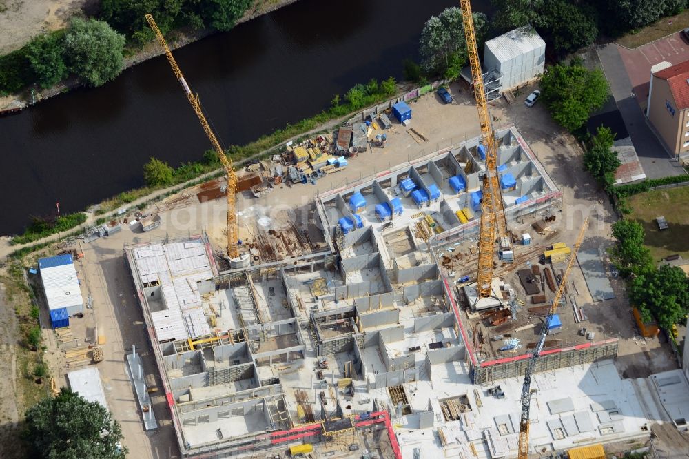 Berlin from above - Construction site of a care home for the elderly in the Baumschulenweg part of the district of Treptow-Köpernick in Berlin in the state of Brandenburg. The future care facility will provide living space for 200 inhabitants. The site is located at the Britzer Verbindungskanal (channel) and the newly built railway bridge. The name Baumschulenweg stems from the former nursery garden located here