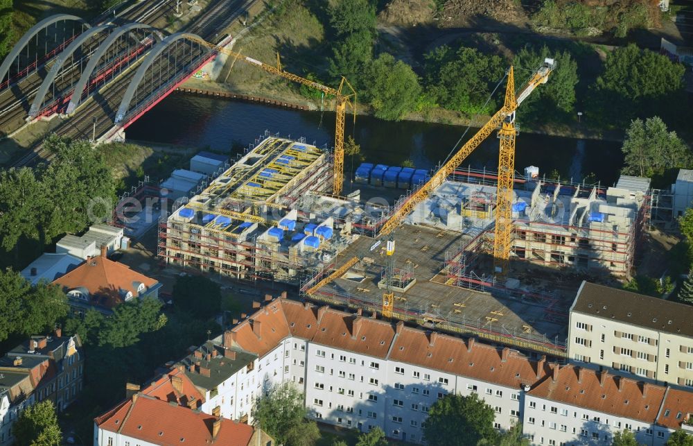 Aerial photograph Berlin - Construction site of a care home for the elderly in the Baumschulenweg part of the district of Treptow-Köpernick in Berlin in the state of Brandenburg. The future care facility will provide living space for 200 inhabitants. The site is located at the Britzer Verbindungskanal (channel) and the newly built railway bridge. The name Baumschulenweg stems from the former nursery garden located here