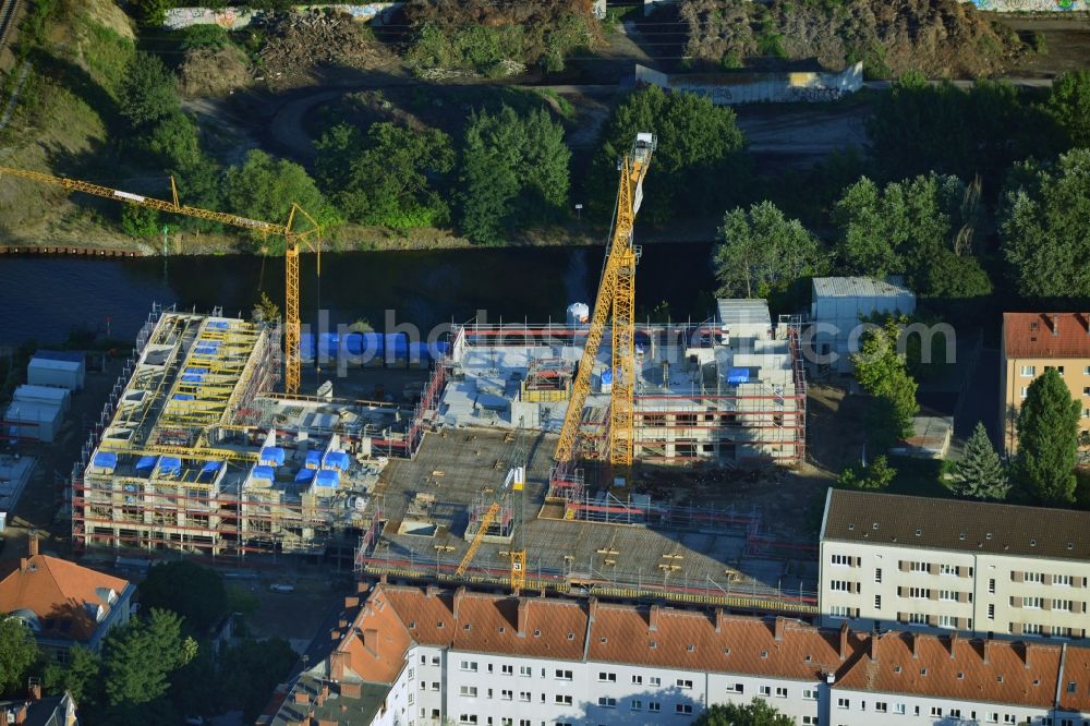 Berlin from above - Construction site of a care home for the elderly in the Baumschulenweg part of the district of Treptow-Köpernick in Berlin in the state of Brandenburg. The future care facility will provide living space for 200 inhabitants. The site is located at the Britzer Verbindungskanal (channel) and the newly built railway bridge. The name Baumschulenweg stems from the former nursery garden located here