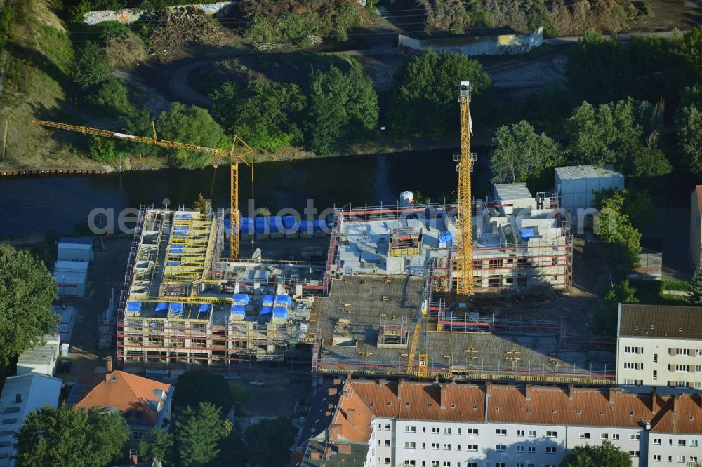 Berlin from the bird's eye view: Construction site of a care home for the elderly in the Baumschulenweg part of the district of Treptow-Köpernick in Berlin in the state of Brandenburg. The future care facility will provide living space for 200 inhabitants. The site is located at the Britzer Verbindungskanal (channel) and the newly built railway bridge. The name Baumschulenweg stems from the former nursery garden located here