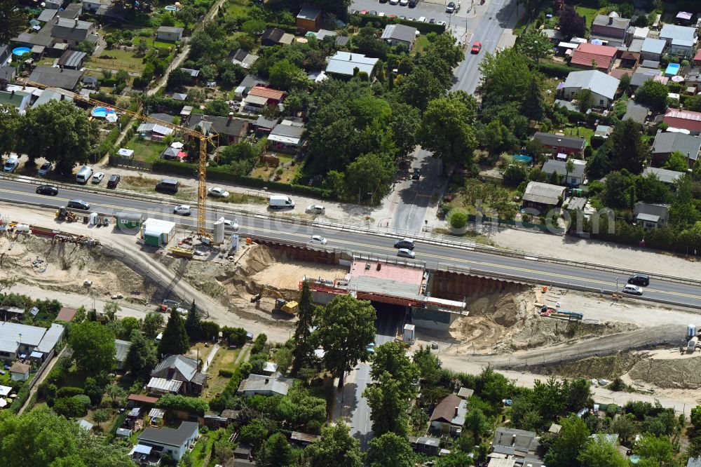 Berlin from the bird's eye view: Construction site for the new building of Routing and traffic lanes over the highway bridge in the motorway A 114 about the Bahnhofstrasse in Berlin Blankenburg in Berlin, Germany