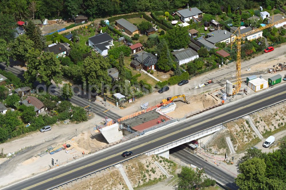 Berlin from the bird's eye view: Construction site for the new building of Routing and traffic lanes over the highway bridge in the motorway A 114 about the Bahnhofstrasse in Berlin Blankenburg in Berlin, Germany