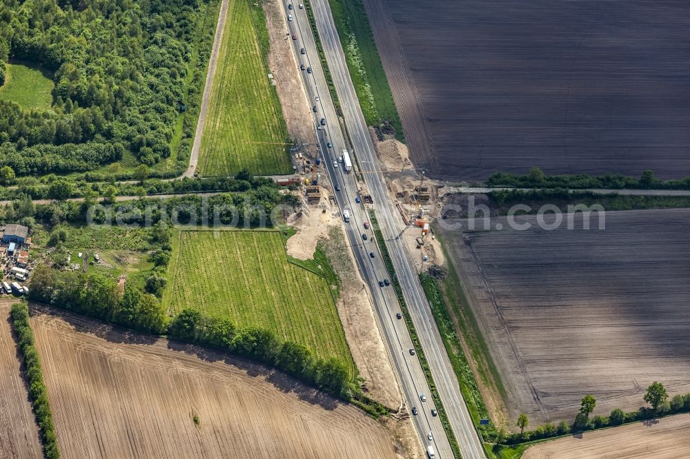 Padenstedt from the bird's eye view: Construction site for the new building of Routing and traffic lanes over the highway bridge in the motorway A 7 in Padenstedt in the state Schleswig-Holstein, Germany