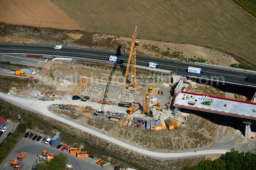 Kürnach from the bird's eye view: Construction site for the new building of Routing and traffic lanes over the highway bridge in the motorway A 7 of Talbruecke Kuernach in Kuernach in the state Bavaria, Germany