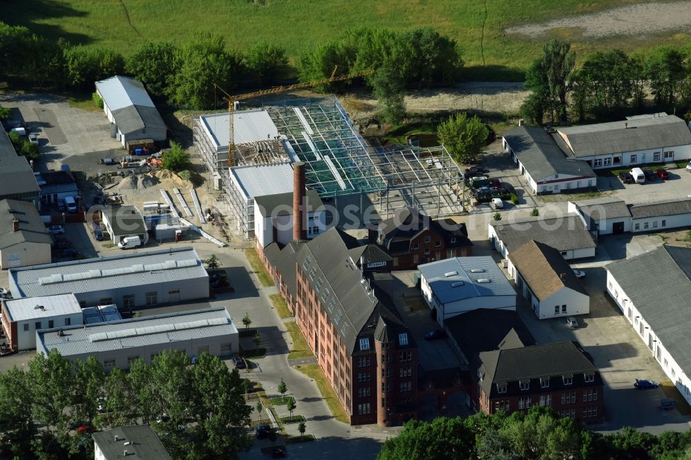 Teltow from above - Construction site at the car trading building of the classics & friends GmbH building in the Iserstrasse at the biomalt farm in Teltow in the state of Brandenburg, Germany