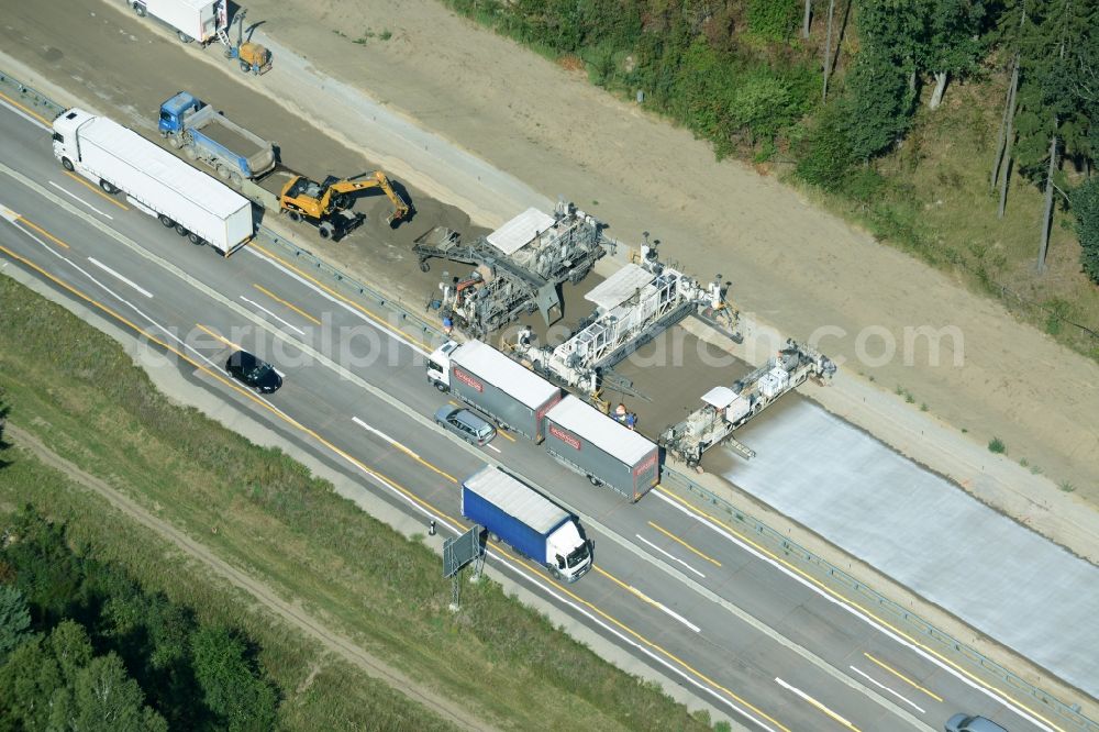 Aerial image Spreenhagen - Highway construction site for the expansion and extension of track along the route of motorway A12 E30 using a concrete paver of the company Eurovia Infra in Spreenhagen in the state Brandenburg