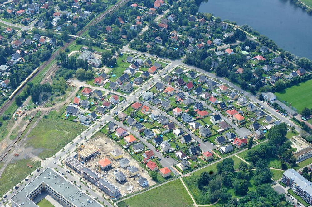 Aerial photograph Berlin Biesdorf - Blick auf die Baufläche des Wohnneubaus an der Haltoner Straße in Berlin Biesdorf am Elterwerdaer Platz. Die NCC Deutschland GmbH errichet hier ein- und Mehrfamilienhäuser , welche den neuesten Energiesparverordnungen EEWärmeG und EnEV2009 entsprechen. Residential building in Berlin Biesdorf.