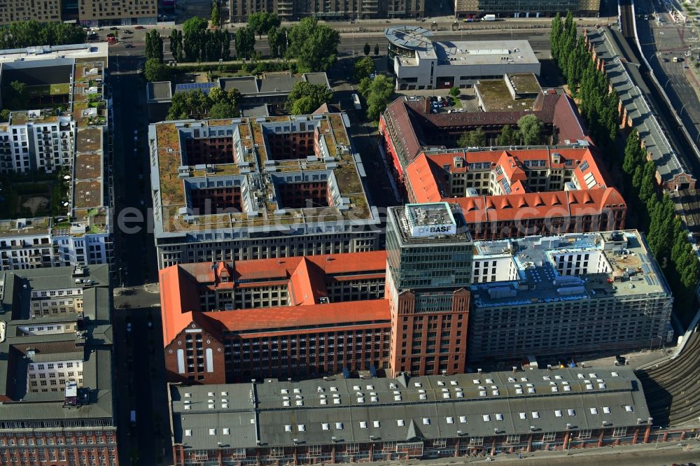 Aerial image Berlin - Construction site on building of the monument protected former Osram respectively Narva company premises Oberbaum City in the district Friedrichshain in Berlin. Here, among many other companies, BASF Services Europe, the German Post Customer Service Center GmbH and Heineken Germany GmbH are located. It is owned by HVB Immobilien AG, which is part of the UniCredit Group