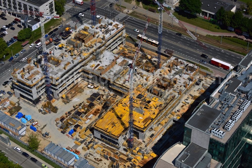 Aerial photograph Warschau - Construction site of the office building Postepu 14 in the Mokotow district of Warsaw in Poland. On site of a former shopping hall on the corner of Postepu and Marynarska streets, a new office building is created. It is a project of the HB Reavis Group and was designed by the architectural office Hermanowicz Rewski Architekci. The building will cover an area of 35 000 square meters office space and will be completed until 2015. The construction site is located in the business district of Mokotow, next to the New City office complex