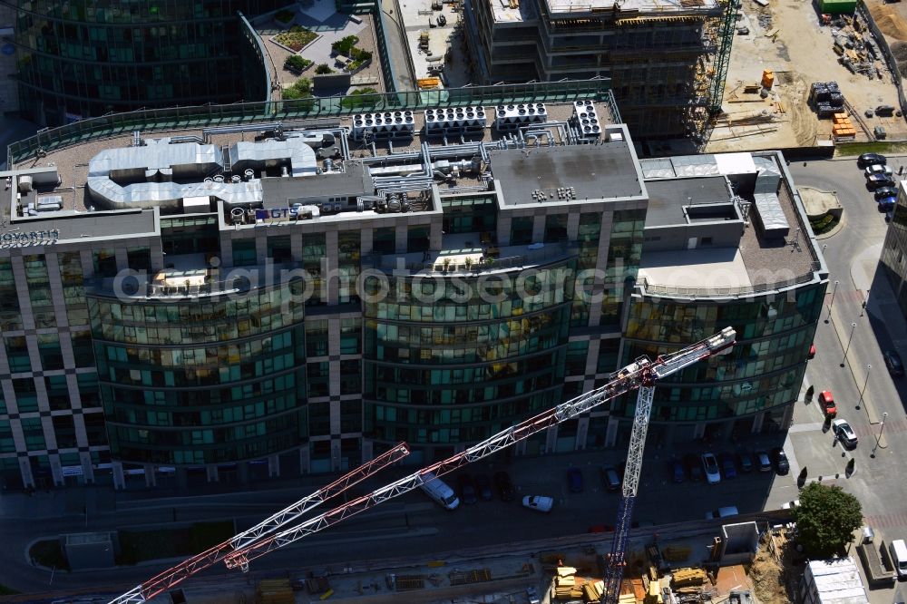 Aerial image Warschau - Construction site of the office building Postepu 14 in the Mokotow district of Warsaw in Poland. On site of a former shopping hall on the corner of Postepu and Marynarska streets, a new office building is created. It is a project of the HB Reavis Group and was designed by the architectural office Hermanowicz Rewski Architekci. The building will cover an area of 35 000 square meters office space and will be completed until 2015. The construction site is located in the business district of Mokotow, next to the New City office complex