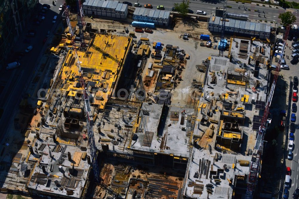 Warschau from the bird's eye view: Construction site of the office building Postepu 14 in the Mokotow district of Warsaw in Poland. On site of a former shopping hall on the corner of Postepu and Marynarska streets, a new office building is created. It is a project of the HB Reavis Group and was designed by the architectural office Hermanowicz Rewski Architekci. The building will cover an area of 35 000 square meters office space and will be completed until 2015. The construction site is located in the business district of Mokotow, next to the New City office complex