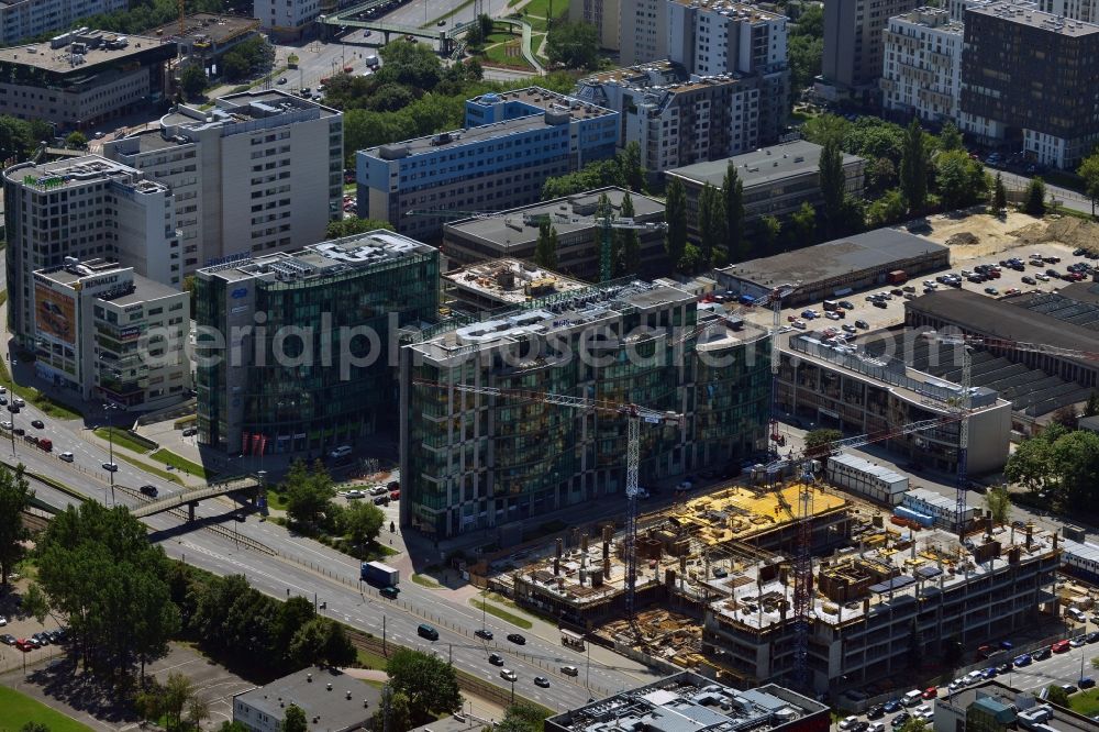 Warschau from the bird's eye view: Construction site of the office building Postepu 14 in the Mokotow district of Warsaw in Poland. On site of a former shopping hall on the corner of Postepu and Marynarska streets, a new office building is created. It is a project of the HB Reavis Group and was designed by the architectural office Hermanowicz Rewski Architekci. The building will cover an area of 35 000 square meters office space and will be completed until 2015. The construction site is located in the business district of Mokotow, next to the New City office complex