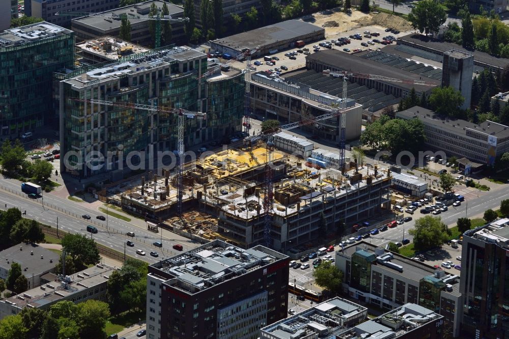 Aerial photograph Warschau - Construction site of the office building Postepu 14 in the Mokotow district of Warsaw in Poland. On site of a former shopping hall on the corner of Postepu and Marynarska streets, a new office building is created. It is a project of the HB Reavis Group and was designed by the architectural office Hermanowicz Rewski Architekci. The building will cover an area of 35 000 square meters office space and will be completed until 2015. The construction site is located in the business district of Mokotow, next to the New City office complex