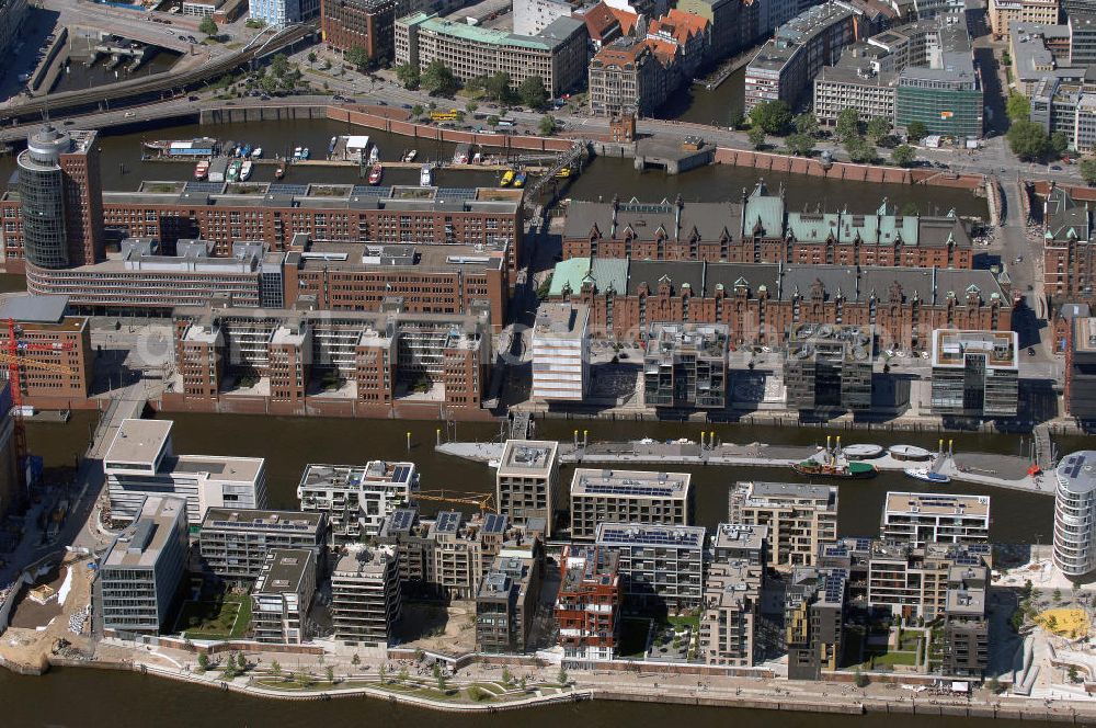 Hamburg from the bird's eye view: Blick auf die Baustelle der neu entstehenden Hafen City. Im Vordergrund der Dalmannkai mit den Projekten / Gebäuden 9-13 und 20-23 und im Hintergrund die Gebäude 1-8 Am Sandtorkai, sowie ein Teil der Speicherstadt. Die HafenCity ist ein Hamburger Stadtteil im Bezirk Hamburg-Mitte. Der 155 Hektar große Stadtteil (mit 60 Hektar Nettobauland) soll neben Büroflächen für mehr als 40.000 Arbeitsplätze, die zu einem Teil schon fertiggestellt sind, auch Wohnraum für 12.000 Einwohner in 5.500 Wohnungen bieten und ist damit das größte laufende Vorhaben zur Stadtentwicklung von Hamburg. Allgemeine Informationen: