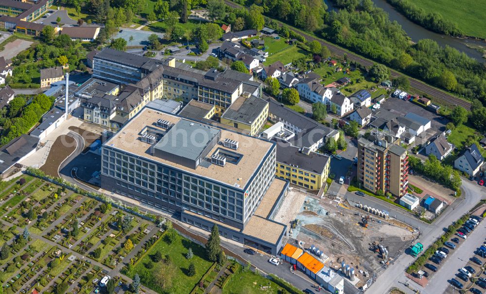 Arnsberg from the bird's eye view: Construction site for a new extension to the hospital grounds Klinikum Hochsauerland - Karolinen-Hospital in the district Huesten in Arnsberg at Sauerland in the state North Rhine-Westphalia, Germany