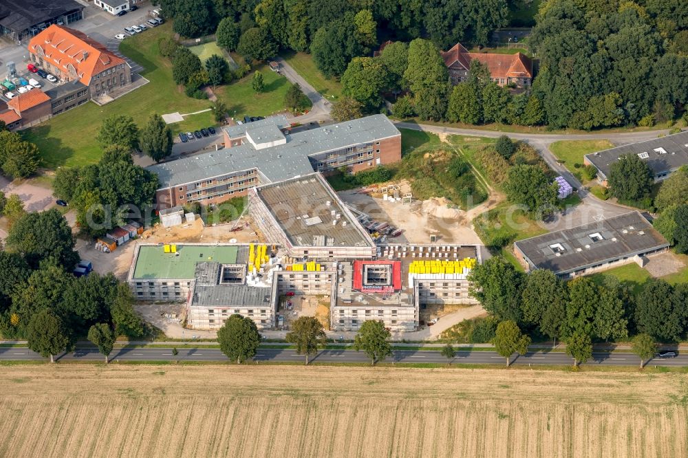 Aerial image Bedburg-Hau - Construction site for a new extension to the hospital grounds LVR-Klinik Bedburg-Hau on Johann-van-Aken-Ring - Gruener Winkel in Bedburg-Hau in the state North Rhine-Westphalia, Germany