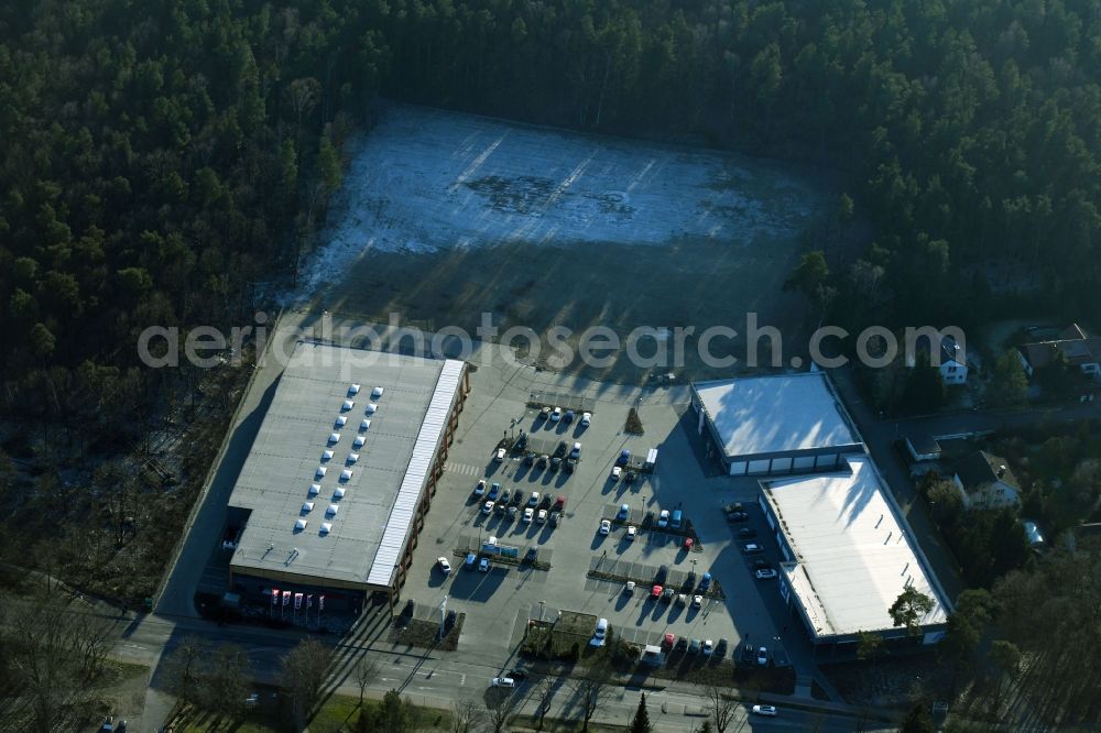 Aerial image Hohen Neuendorf - Construction site of a new shopping center and store of the Supermarket REWE in Hohen Neuendorf in the state of Brandenburg. A new shopping facility with stores is being built as part of the regeneration of the shopping center HDZ on Schoenfliesser Strasse. The project is carried out by GVG Projektentwicklungsgesellschaft mbH