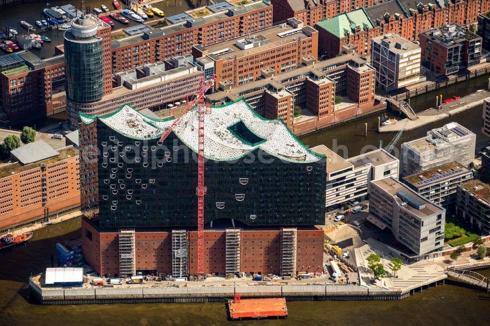 Hamburg from above - The Elbe Philharmonic Hall on the river bank of the Elbe in Hamburg. The building in the district HafenCity is still in process of construction