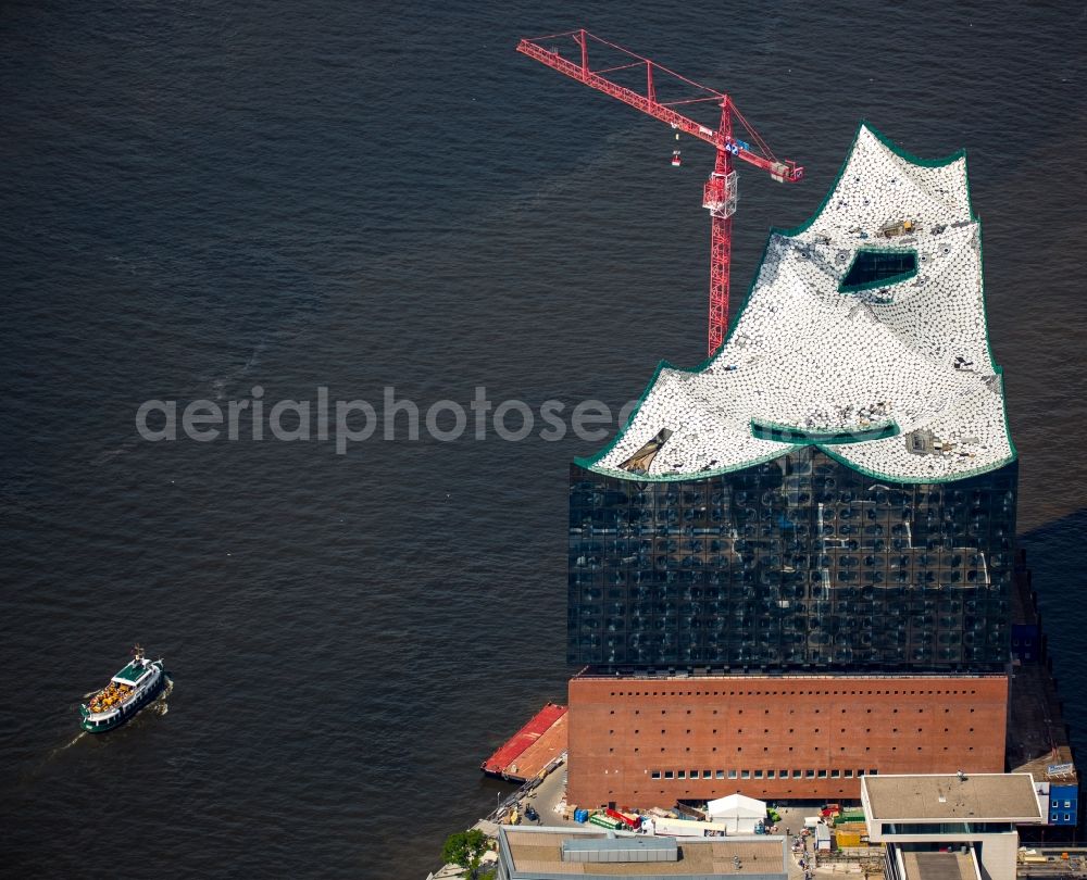 Hamburg from above - The Elbe Philharmonic Hall on the river bank of the Elbe in Hamburg. The building in the district HafenCity is still in process of construction