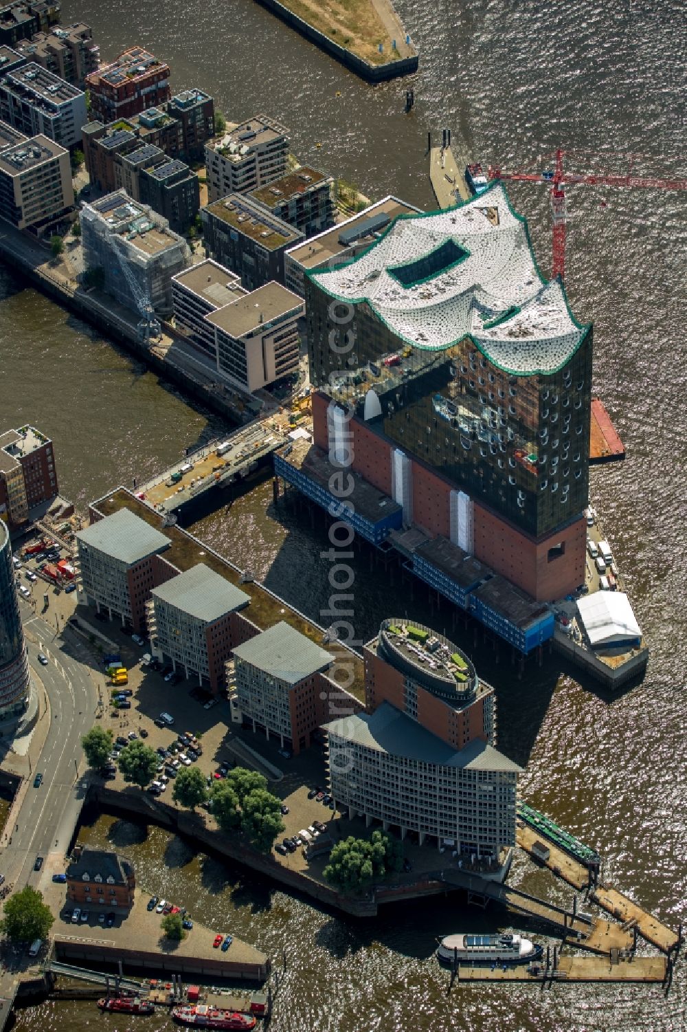 Hamburg from above - The Elbe Philharmonic Hall on the river bank of the Elbe in Hamburg. The building in the district HafenCity is still in process of construction