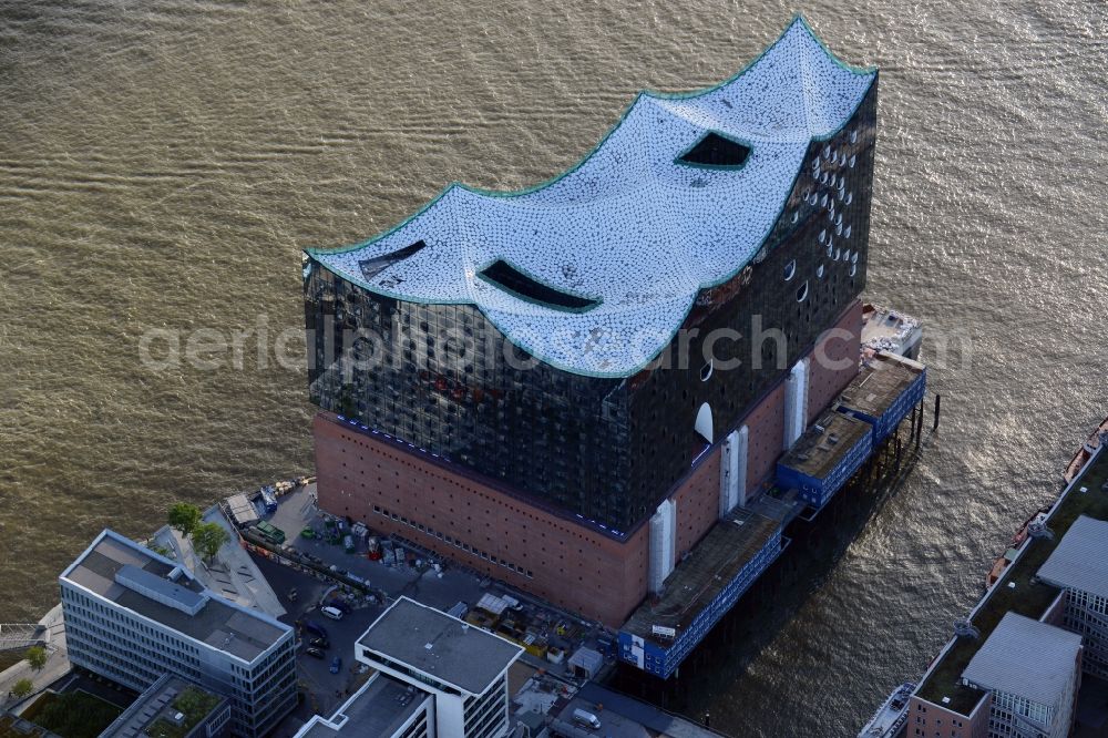 Hamburg from above - The Elbe Philharmonic Hall on the river bank of the Elbe in Hamburg. The building in the district HafenCity is still in process of construction