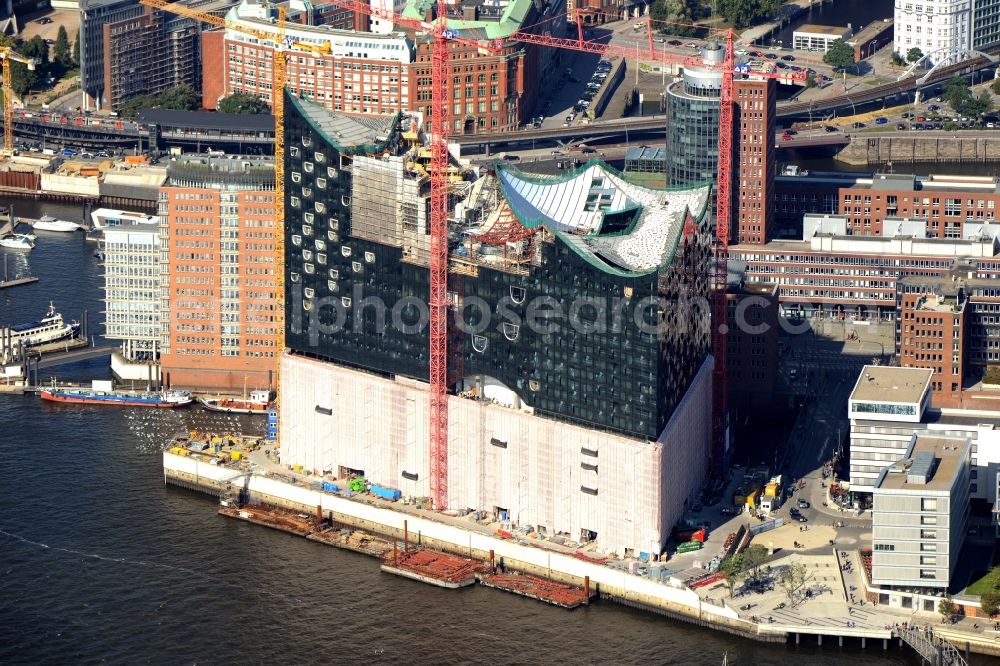 Hamburg from above - The Elbe Philharmonic Hall on the river bank of the Elbe in Hamburg. The building in the district HafenCity is still in process of construction